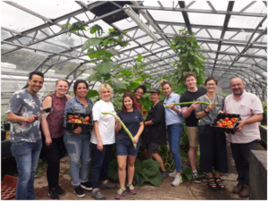 A group of volunteers smiling to camera at the Wolves Lane Kitchen Garden