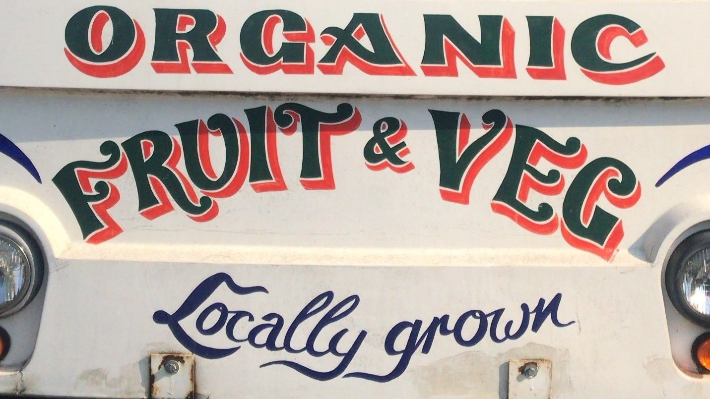 Van bonnet featuring the signage Organic Fruit and Veg locally grown.
